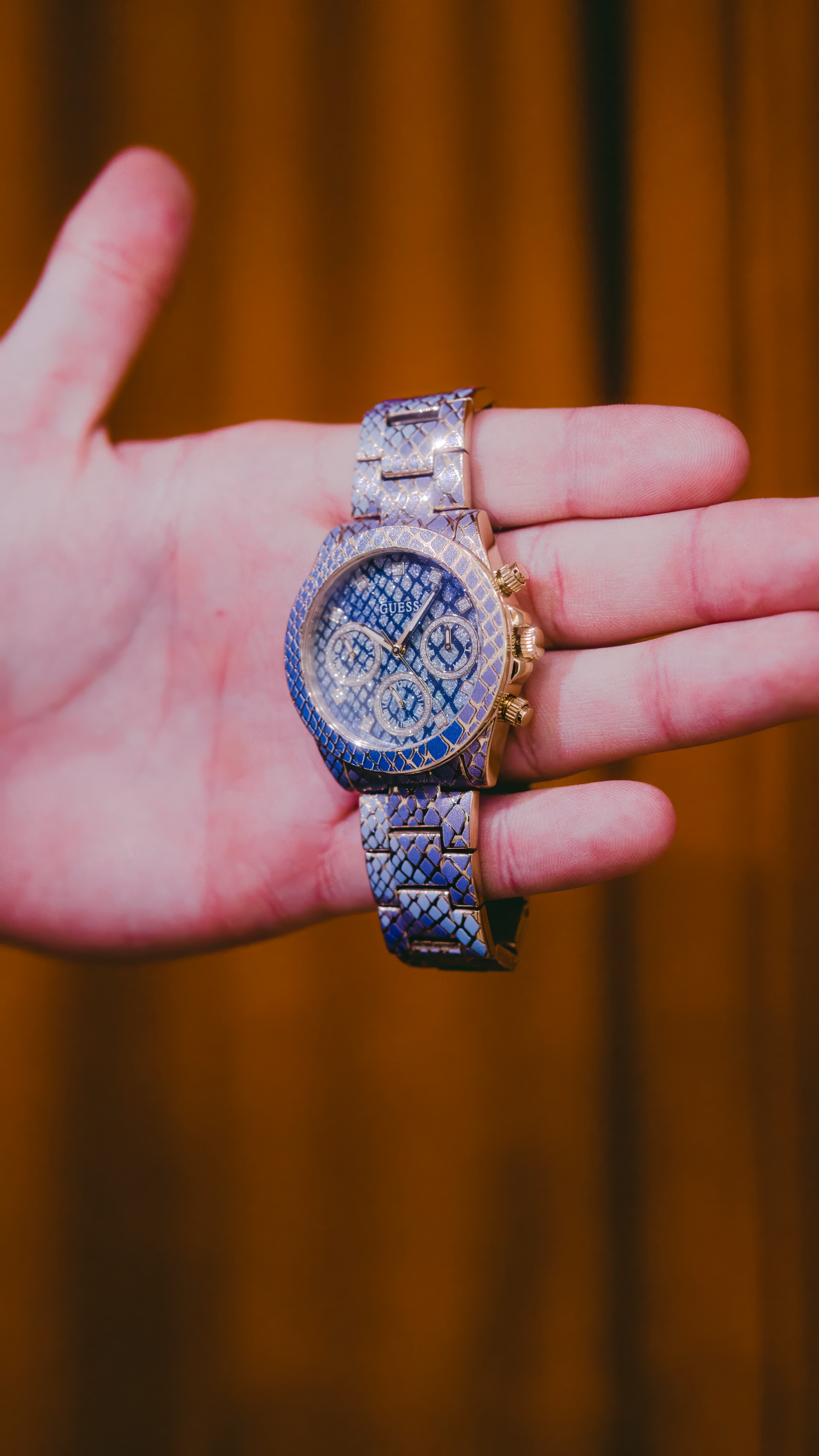 Luxury wristwatch held in hand at a Pulito showcase