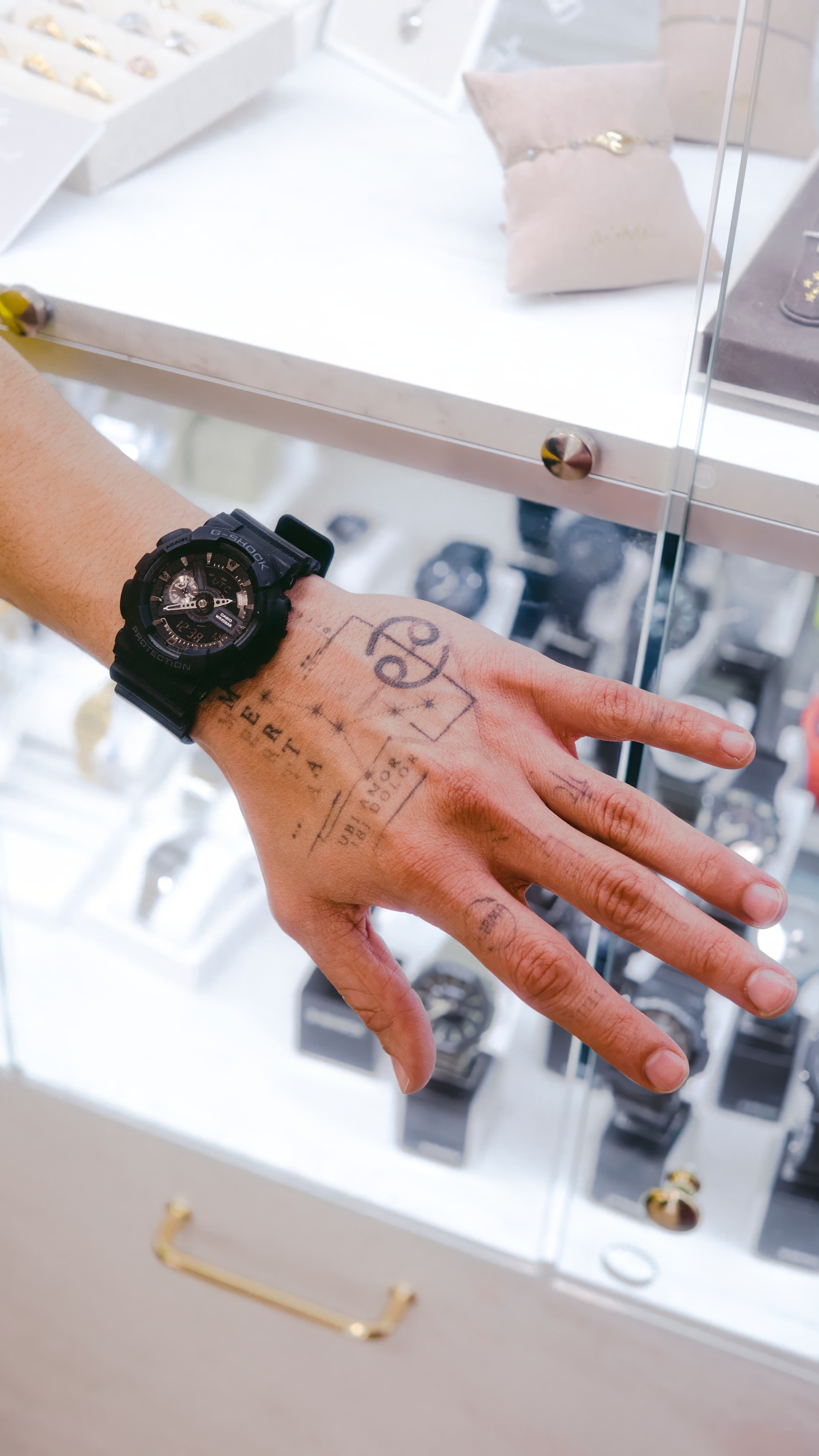 Customer exploring watches at a Pulito display